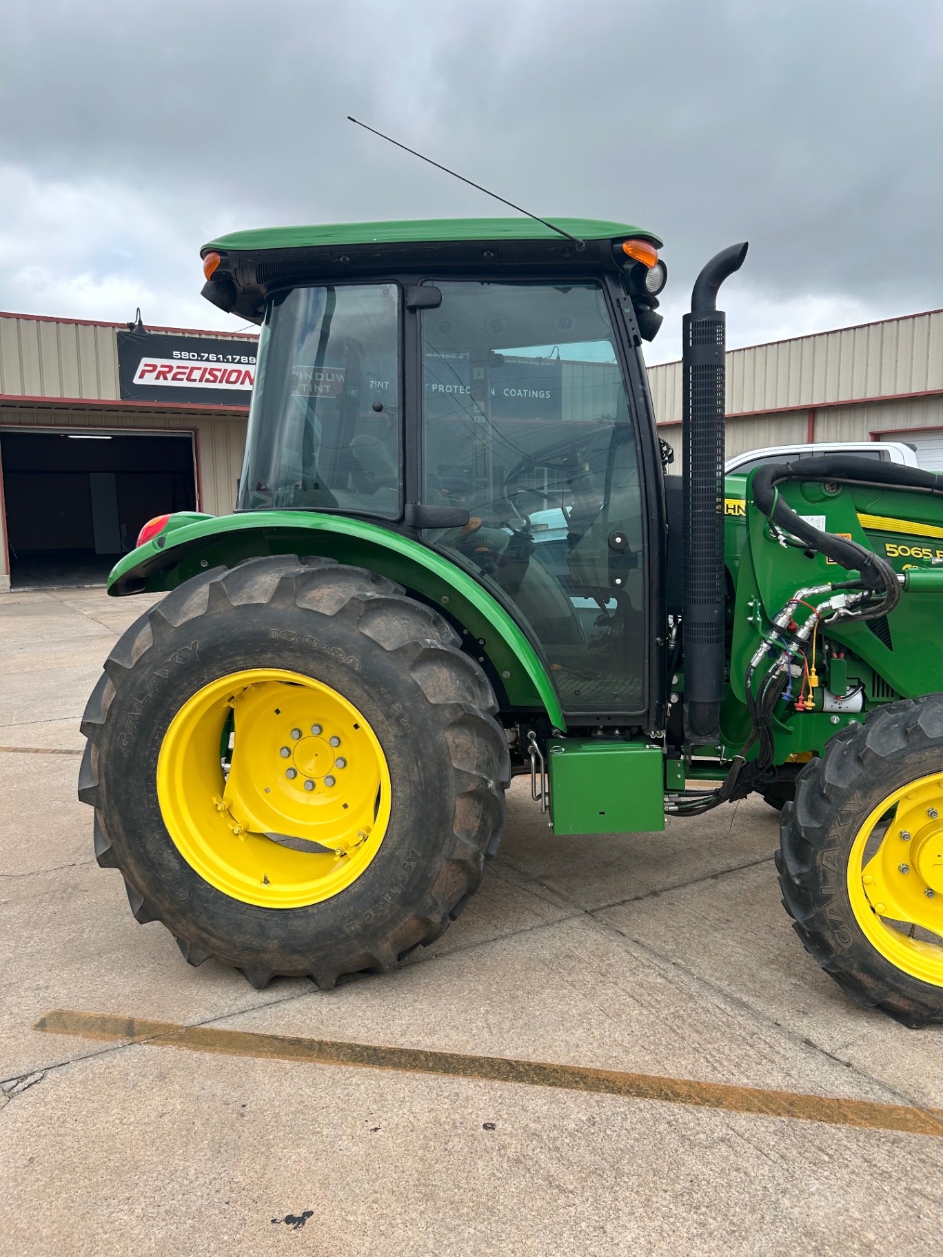 John Deere 5065E tractor cab before tint service at Precision Window Tint