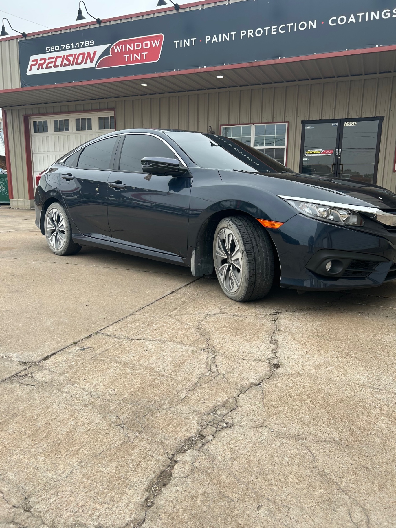 Dark blue Honda Civic with ceramic window tint at Precision Window Tint