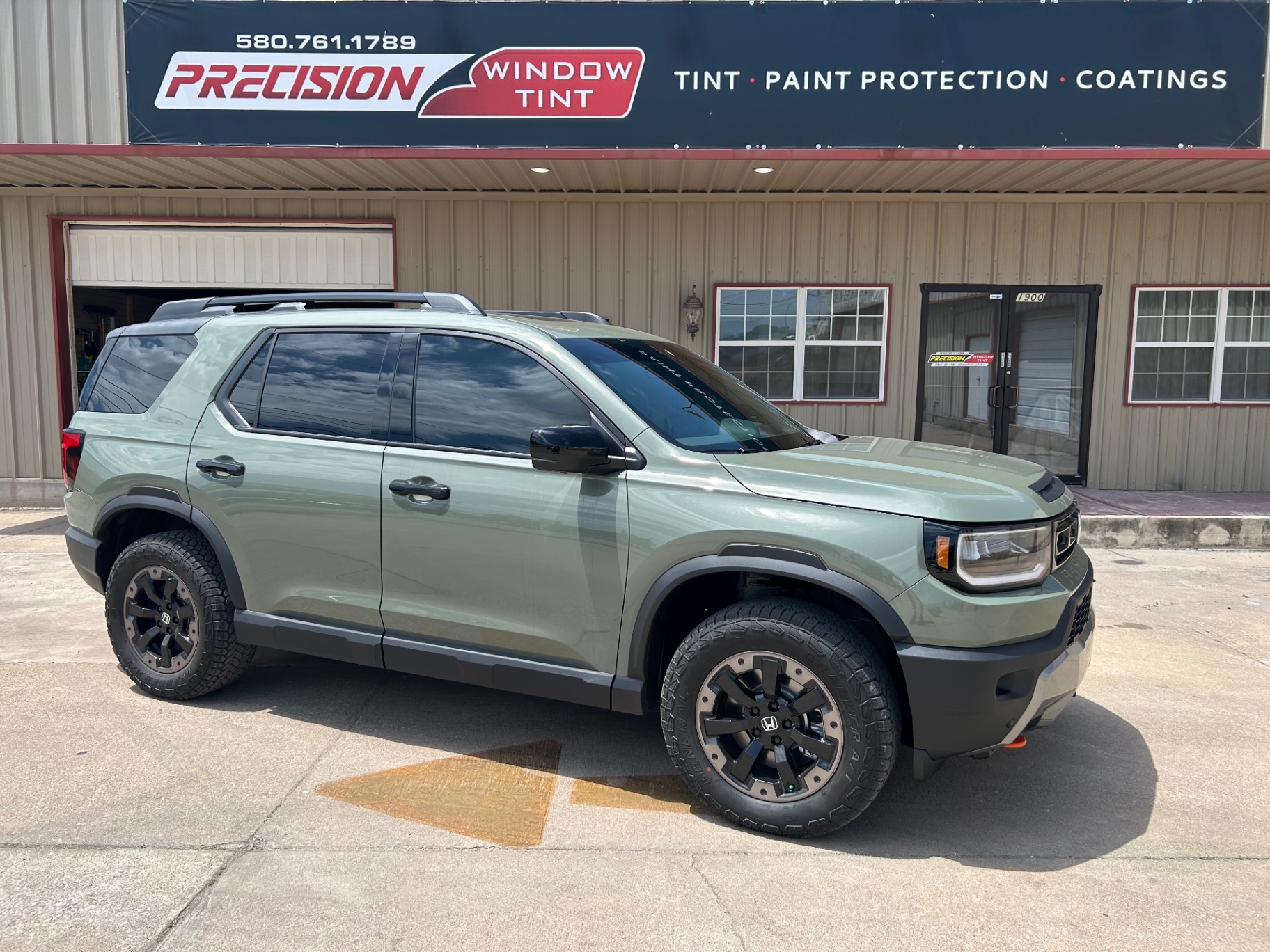 Green Honda Passport TrailSport with window tint at Precision Window Tint Ponca City