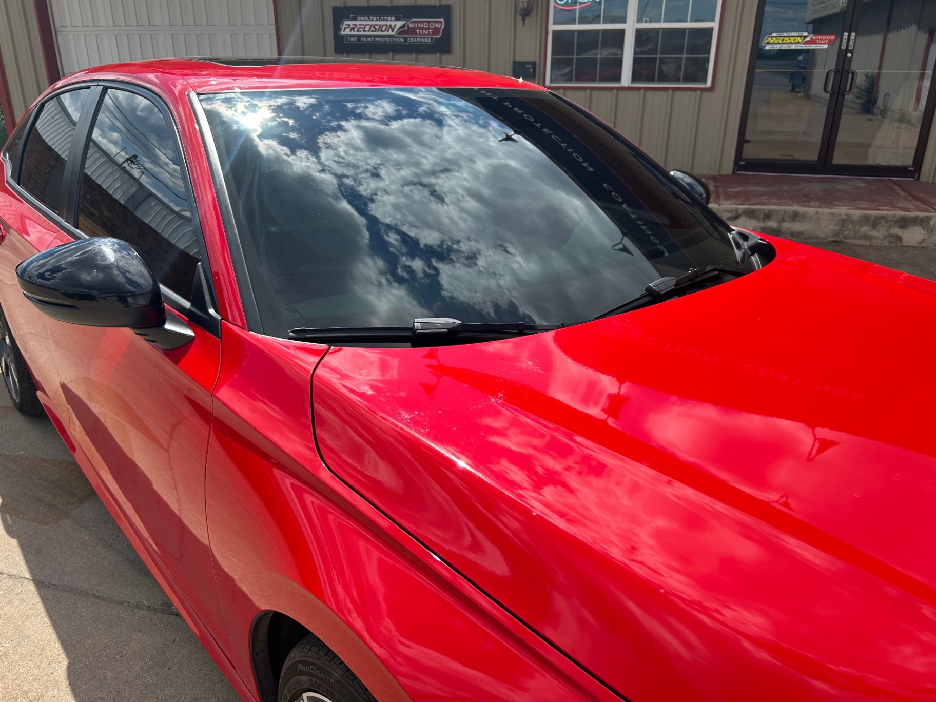 Red sedan with glossy ceramic coating and windshield protection — Precision Window Tint