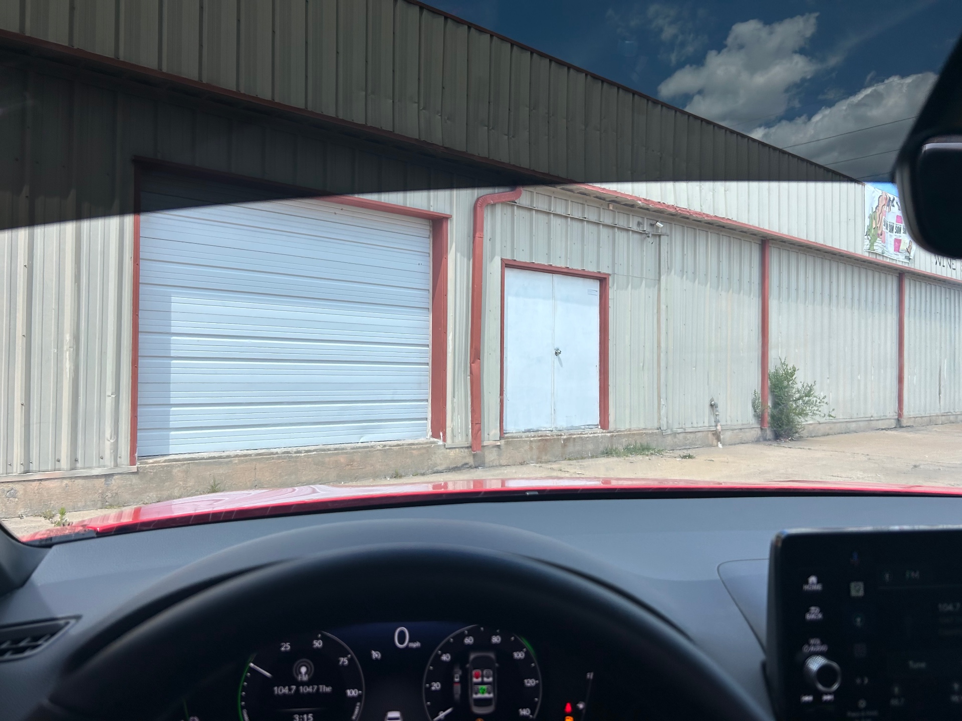 Interior driver view showing windshield shade strip and side glass tint