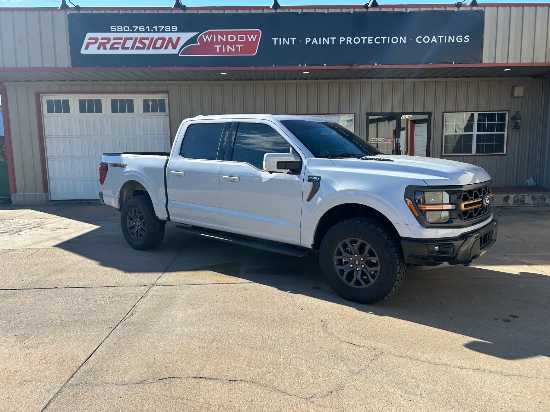 White Ford F-150 Tremor with dark window tint at Precision Window Tint Ponca City