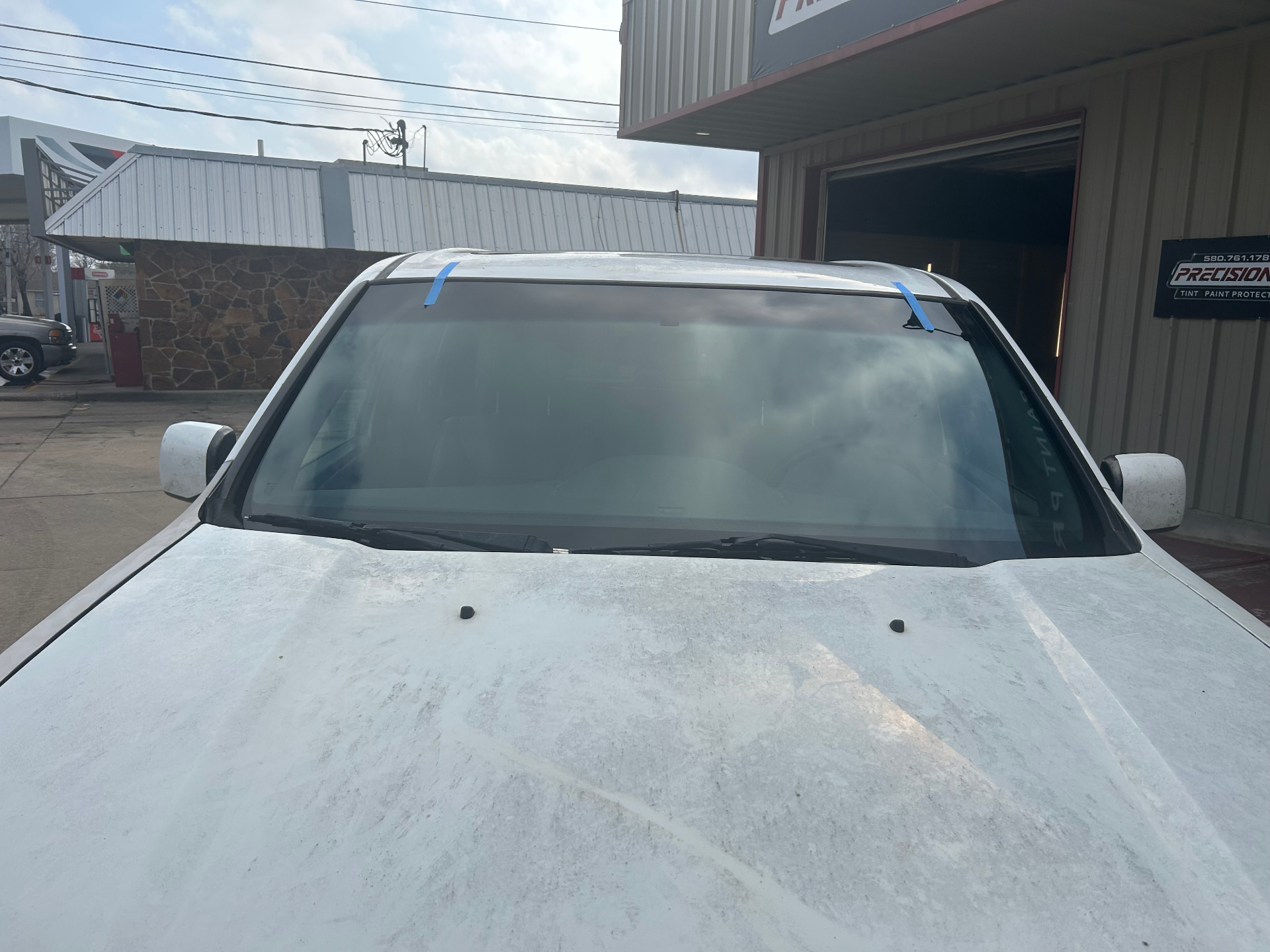 Completed windshield replacement outside the shop