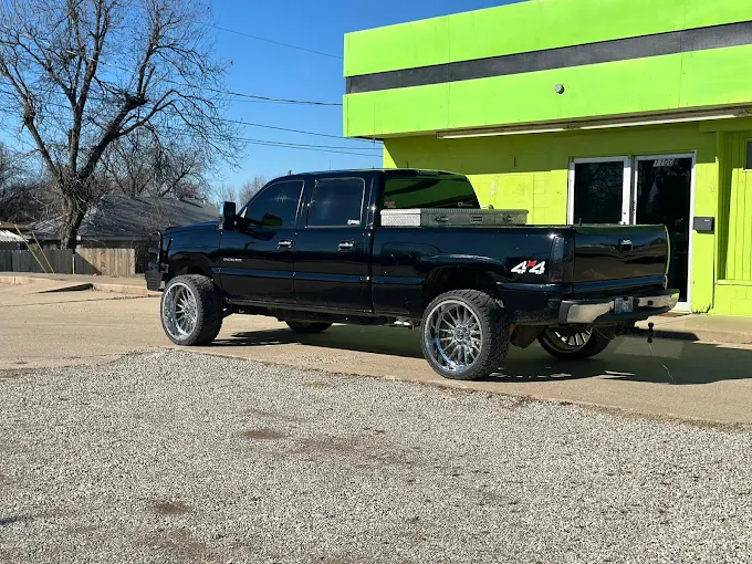 Black Chevy Silverado 4x4 with dark tint at Precision Window Tint