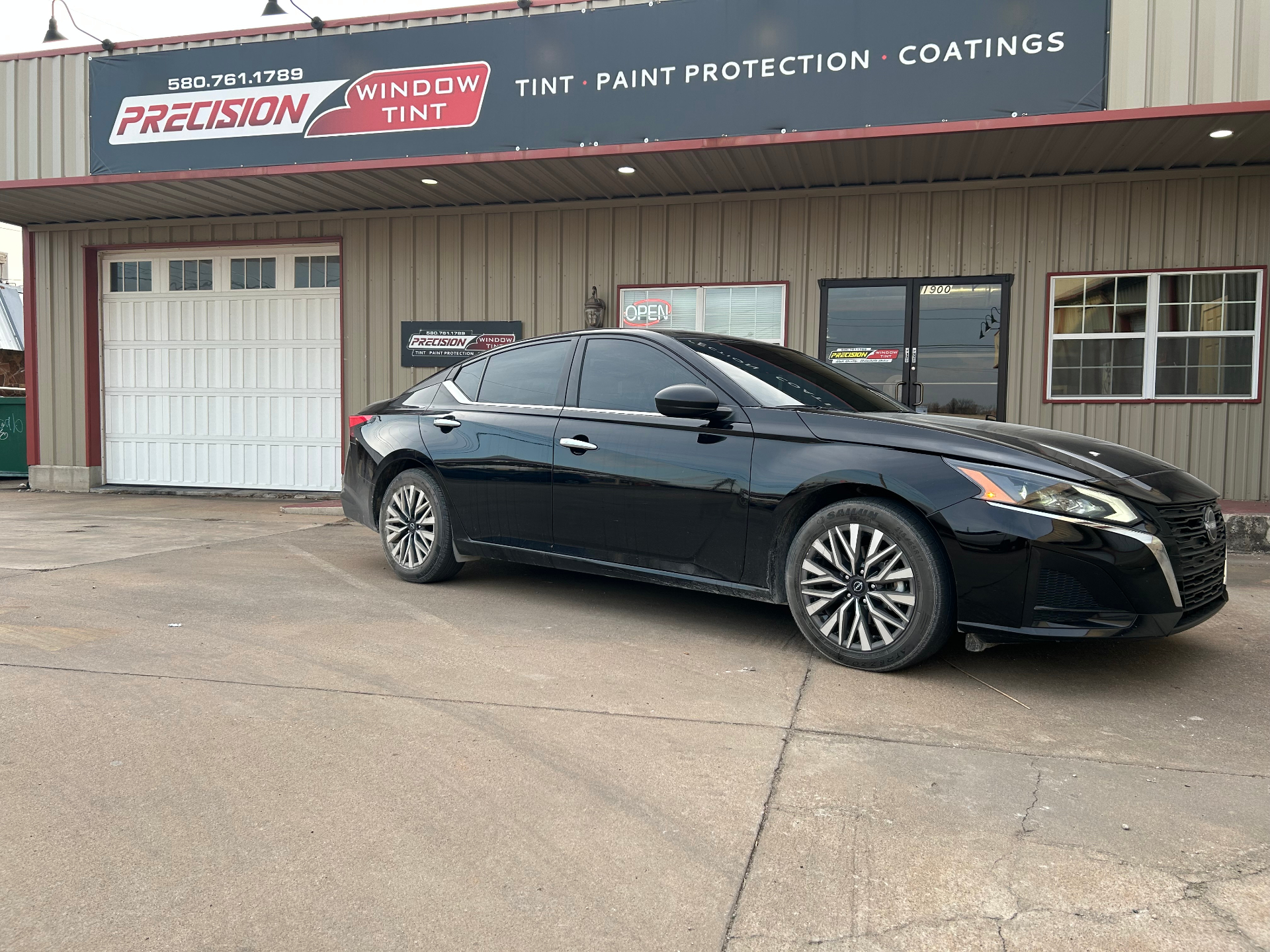 Black Nissan Altima with freshly tinted windows
